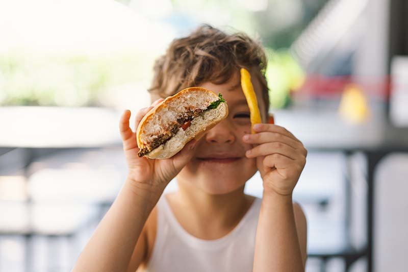 A young customer with a sandwich and fries